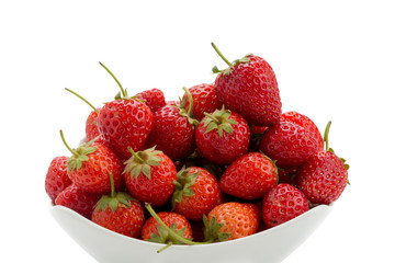 Fresh ripe strawberries in small white bowl on white background.