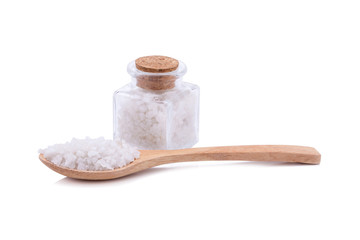 Closeup Himalayan salt in wooden spoon and bottle on white background
