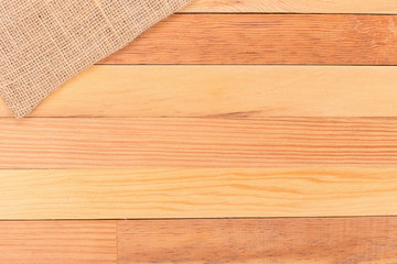 Fabric on wooden table. Soft brown woven linen fabric texture / white wood texture background