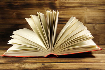Open book on wooden background