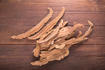 Dried lingzhi mushroom (Also called as Reishi mushroom in Japan Lingcheu in Thailand Lingzhi mushroom in China Ganoderma Lucidum Karst or lacquered mushroom) on dark background.
