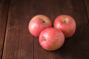 red apple on a wooden background.