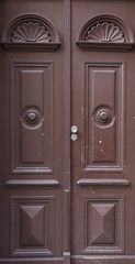 The vintage brown  wooden front door of an old house