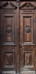 The vintage brown  wooden front door of an old house