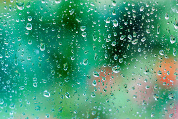 Water drops on glass on green background