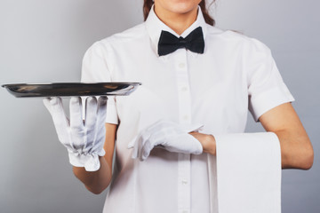 Woman waitress with a tray in the hand