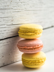 Colorful macaroons on wooden background