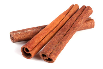 three cinnamon sticks isolated on white background
