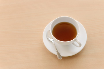 cup of hot tea on wooden table