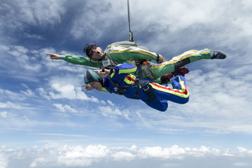 Tandem jump. The girl with the instructor in freefall.