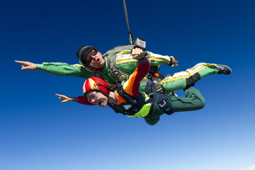 Tandem jump. The girl with the instructor in freefall.