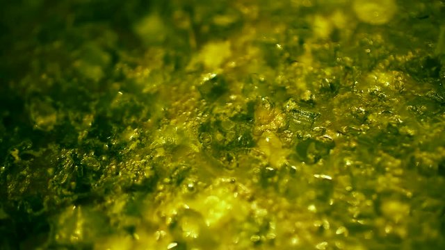 Mixing freshly prepared soup of meat, with rice, potatoes and green onions. Top view close-up.