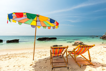 Colorful chairs and umbrella on tropical beach at Koh Khai Nok Island.Phuket Province.Thailand