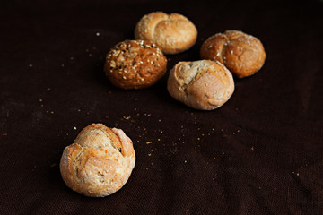 variety of small breads with seeds isolated on black background