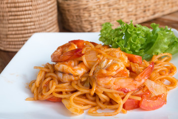 Close up stir fried spaghetti and prawn with tomato sauce