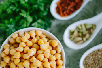Roasted spicy chickpeas on green background, top view