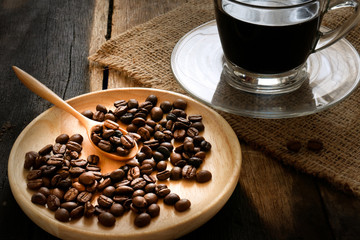 The black coffee and bean on spoon and cup.