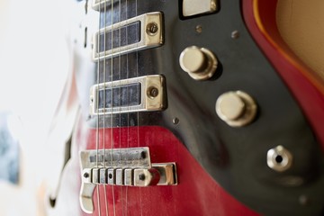  Old excellent electro and bass guitars on the shelf in the guitar shop