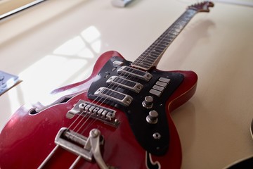  Old excellent electro and bass guitars on the shelf in the guitar shop