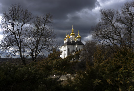 Landscape with Catherine's Church, cloudy sky, sun and trees without leaves, early march, Chernigiv, Ukraine, photo shoot with fisheye lens
