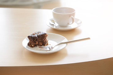 Brownie with coffee on wooden table