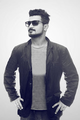 Handsome fashion man smiling and wearing sunglasses