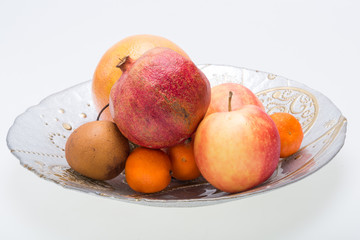 mix fresh fruits on plate isolated on white