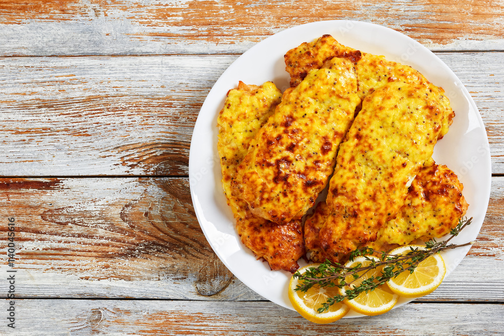 Poster baked chicken breast coated with melted cheese