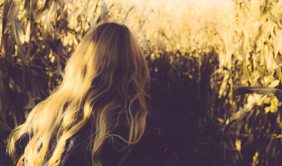 A Blond Woman in a Corn Maze