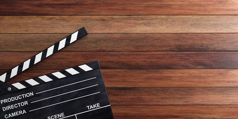 Obraz premium Movie clapper on wooden surface. 3d illustration