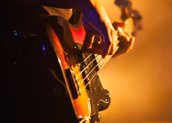 Closeup photo of bass guitar player