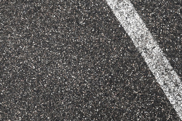 White dividing line on dark gray tarmac