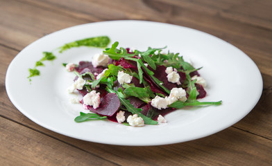 Salad with beet, feta, arugula and pesto.