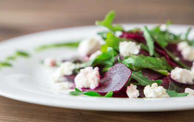 Salad with beet, feta, arugula and pesto.