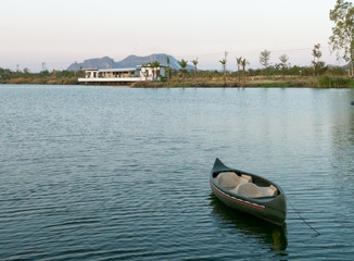 Fototapeta premium Small boat on Ticino lake at sunset, Thailand