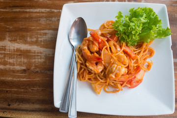 Close up stir fried spaghetti and prawn with tomato sauce