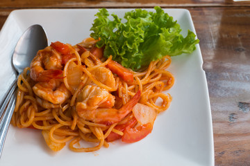 Close up stir fried spaghetti and prawn with tomato sauce