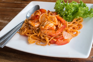 Close up stir fried spaghetti and prawn with tomato sauce