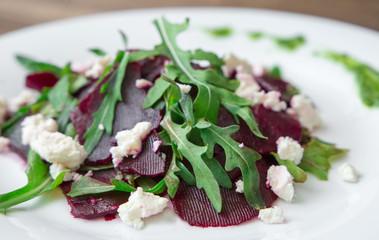 Salad with beet, feta, arugula and pesto.