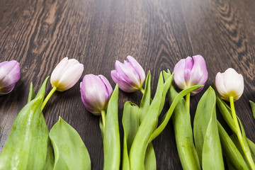 Bouquet of tulips on a wooden background.