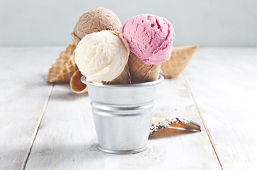 Various ice cream cones are in the metal basket.