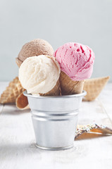 Various ice cream cones are in the metal basket.