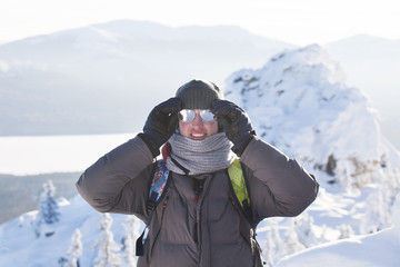 Fototapeta na wymiar Man near rocks. Mountain range Zyuratkul, winter