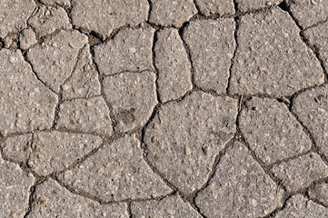 Cracked asphalt road surface texture. Grey texture of the road