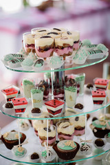 Tired glass dish served with different kinds of chocolates