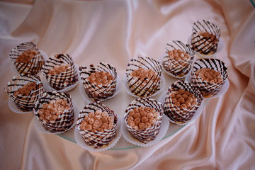 Tiramissu cakes stand on pink silk cloth