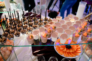 Glasses with cold desserts stand on glass box