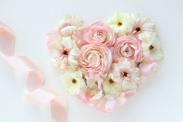 Hear-tshaped bouquet of beautiful ranunculus flowers with ribbon