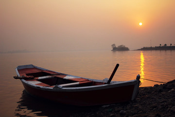 Naklejka na ściany i meble A boat during the beautiful sunset
