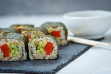 Healthy homemade sushi rolls with brown rice and fish.
